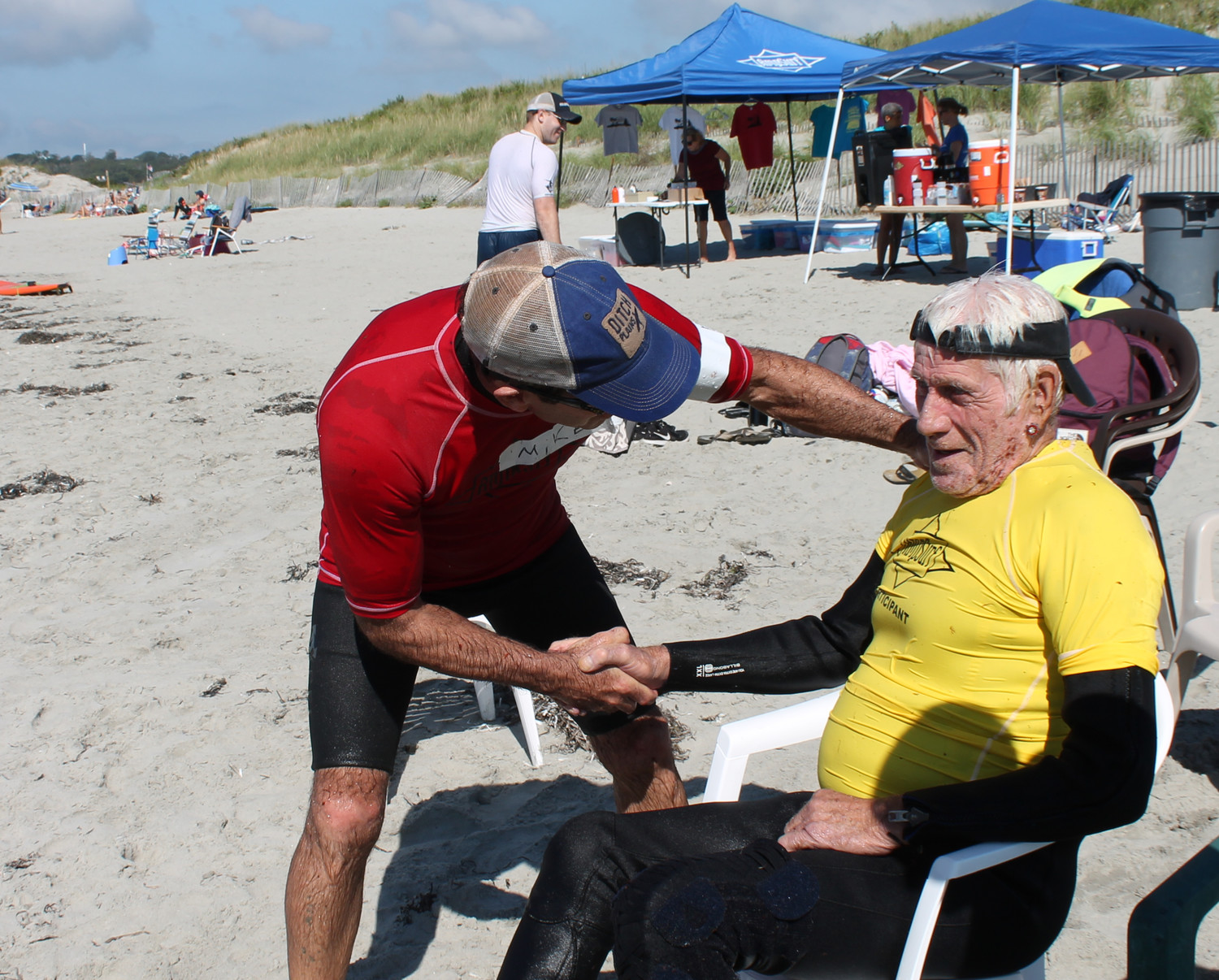 Mike Tubridy of AmpSurf congratulates Stu Stewart after a great surf on the waves.